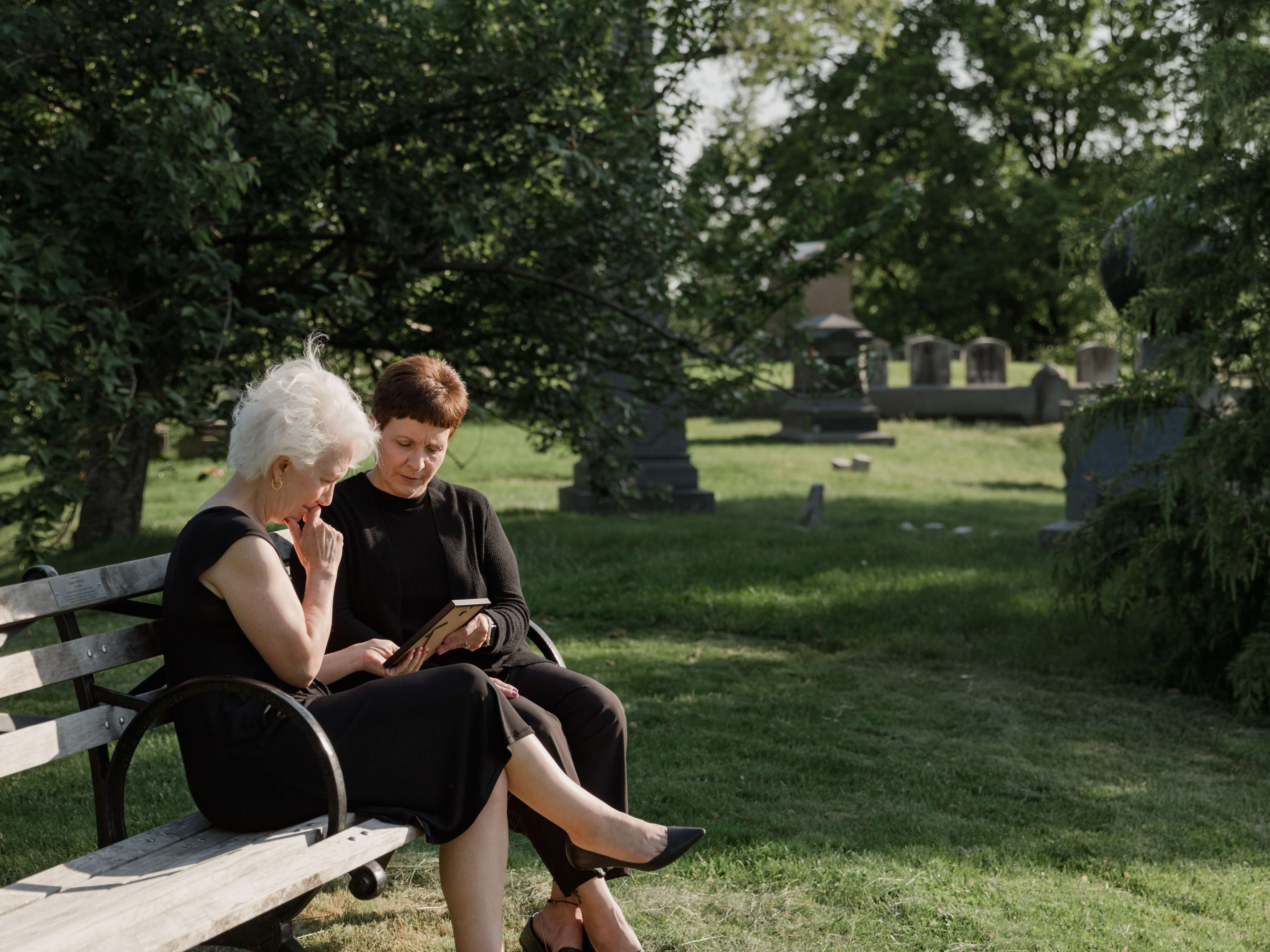 People In Cemetery grieving